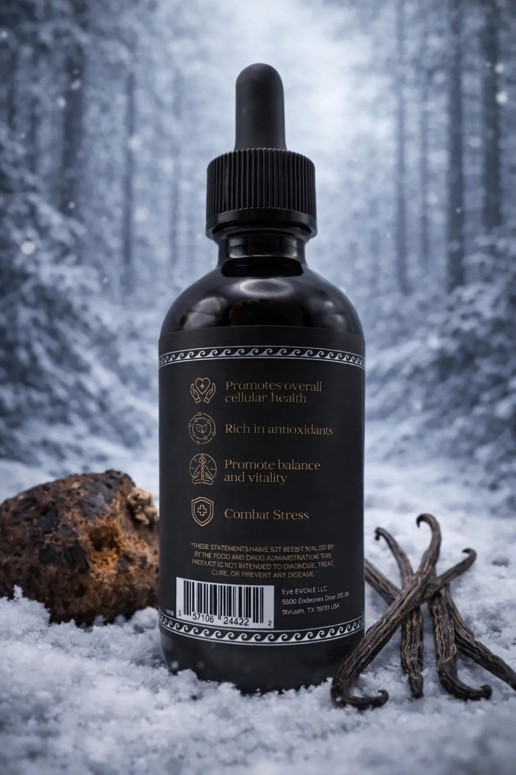 Bottle of tincture with vanilla beans and truffle in a snowy forest setting
