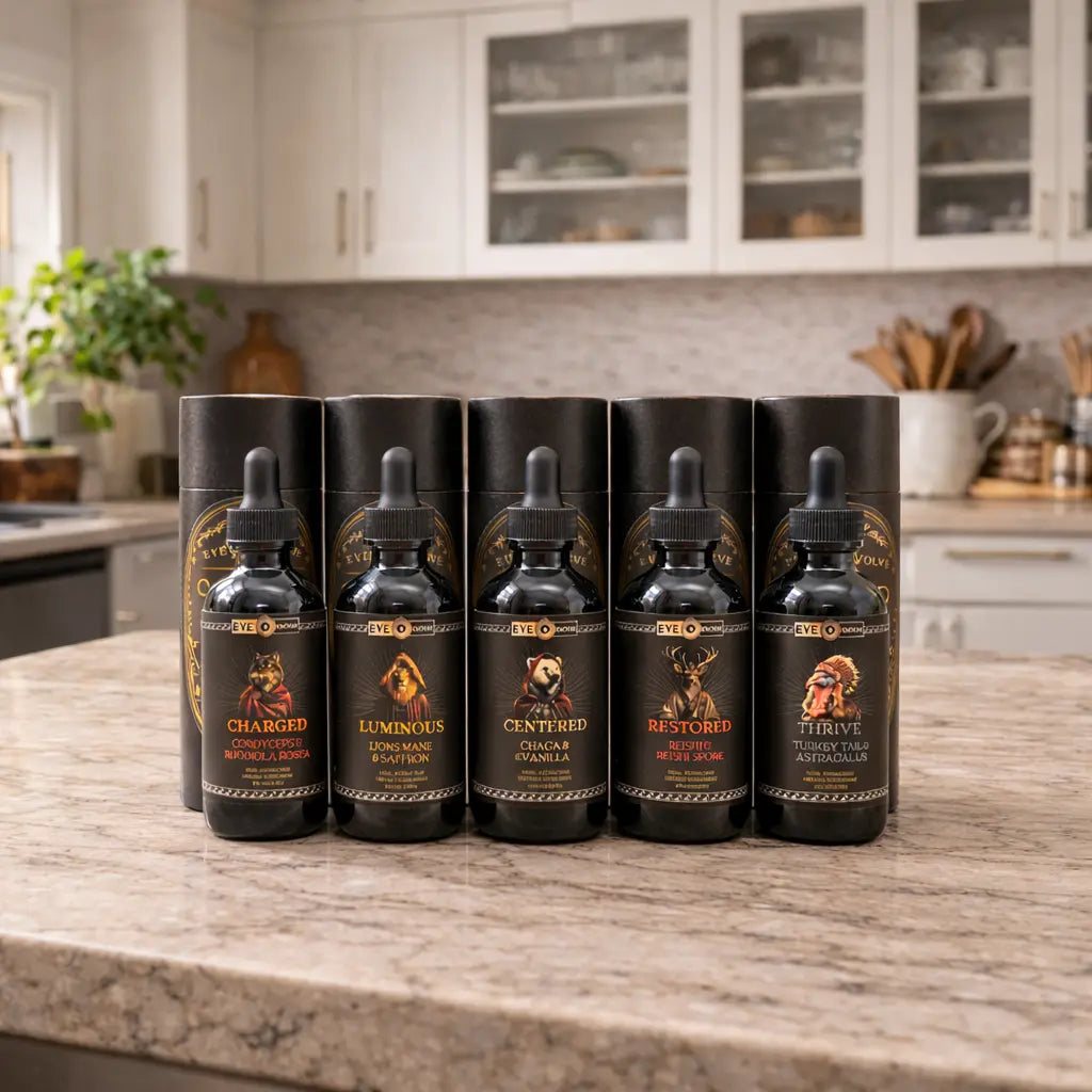 Five black bottles with droppers on a kitchen counter
